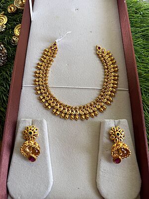 Traditional peacock design with unique stone neckpiece