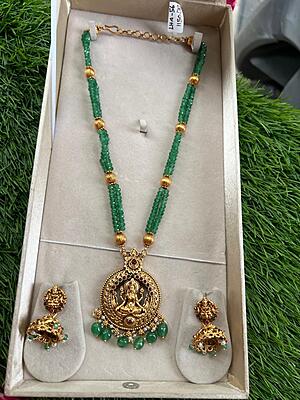 Unique lakshmi design within circle and green beads longharam