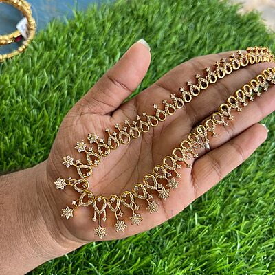 Gold finished Long haram with AD flower design Gold finished Long haram with AD flower design