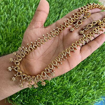 Gold finished Long haram with AD flower design