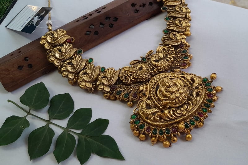 brad pink with green stone neckpiece