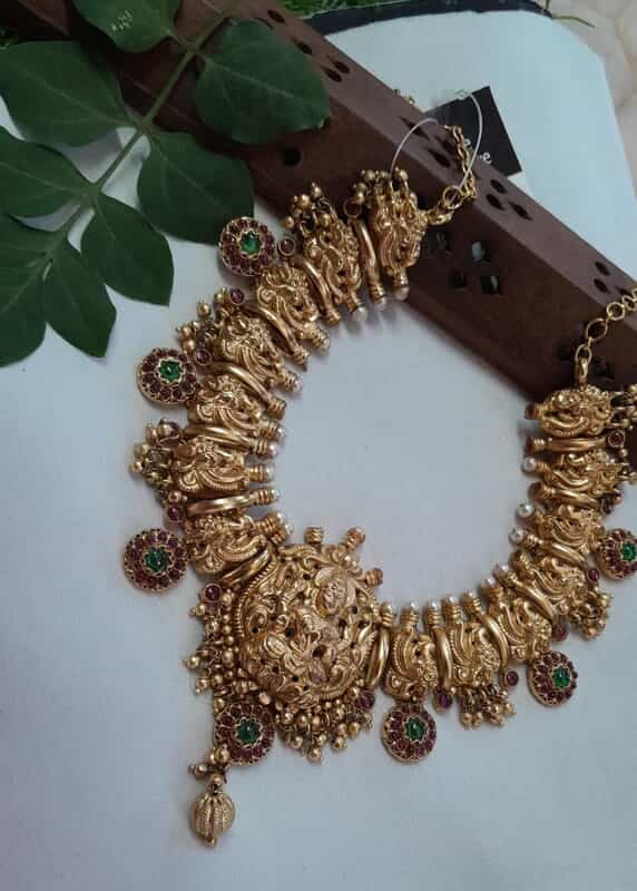 peacock with red stone neckpiece